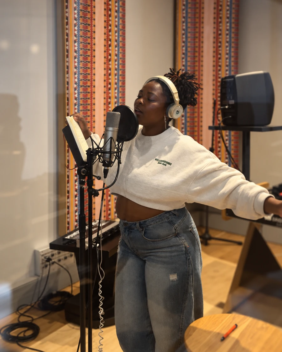 Singer recording vocals at the microphone in a Cape Town studio